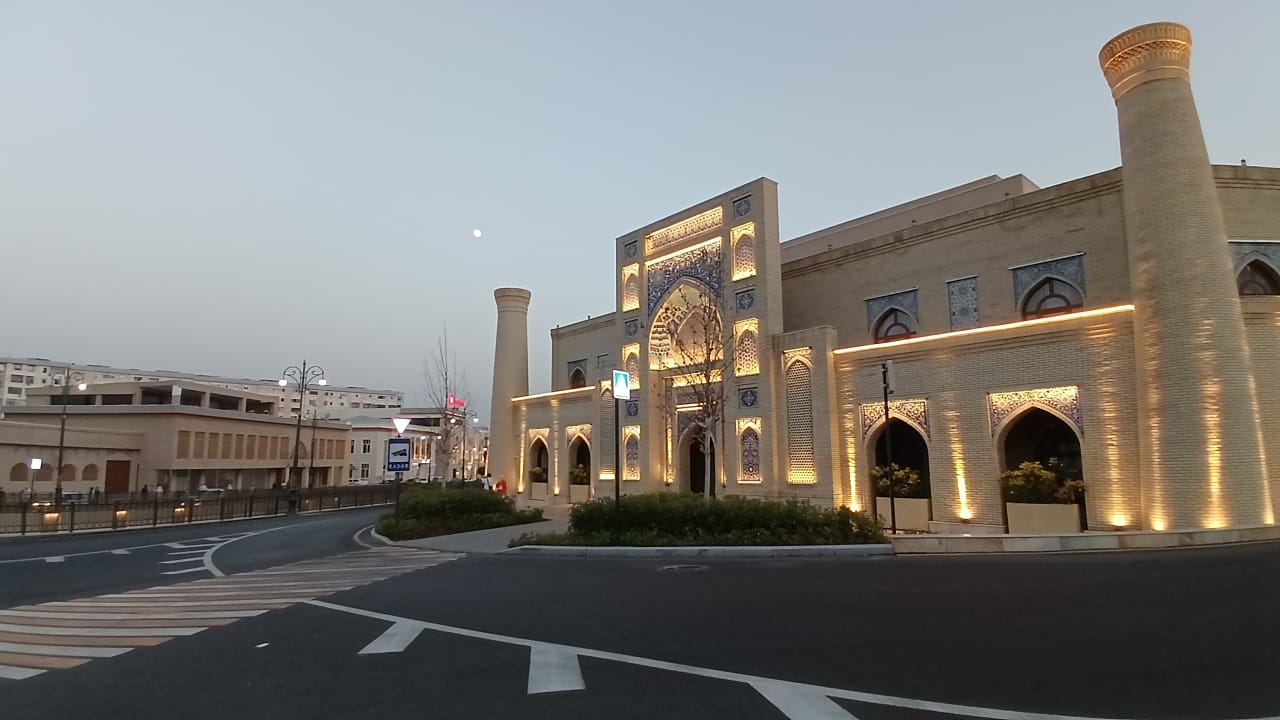 Illuminated facade of Mecca Boutique Hotel at dusk