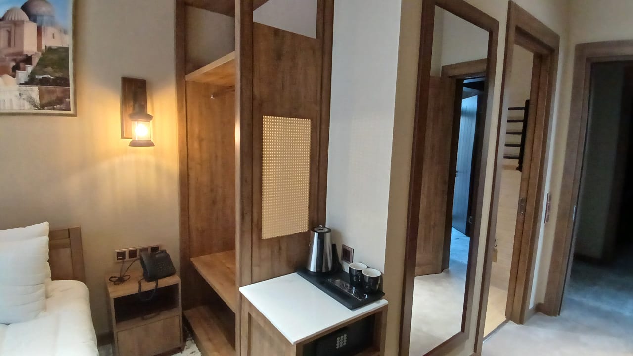Guest room details in warm wood and neutral tones